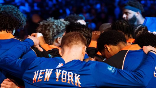 New York Knicks players huddle together before NBA game tips off