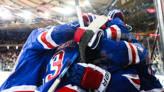 New York Rangers hockey players celebrate together at Madison Square Garden in NYC