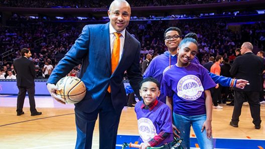 John Starks poses for photo with kids during Garden of Dreams Foundation event