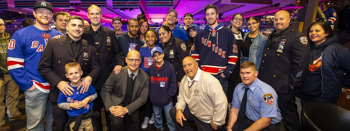 Attendees pose for a photo during the New York Rangers game against the Tampa Bay Lightning