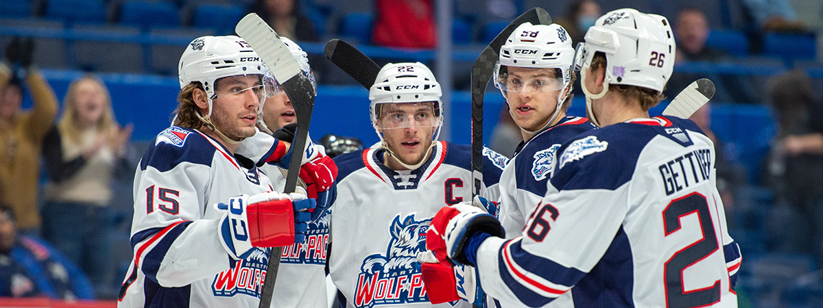 Players of American Hockey League team, Hartford Wolfpack, huddle together on the ice